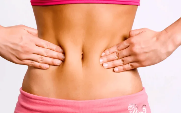 Hands resting on a bare stomach