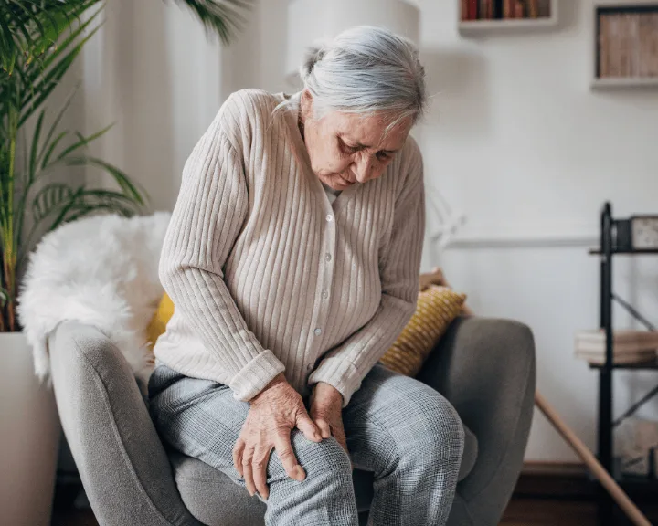 Woman holding her knee